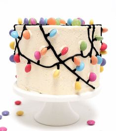 a white cake topped with lots of colorful candies