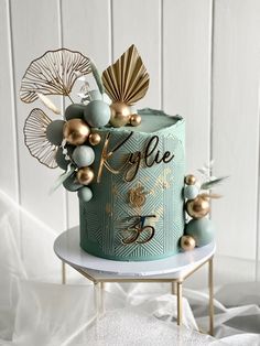 a blue cake with gold decorations on top