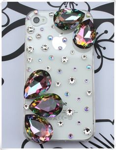 an iphone case with some jewels on it