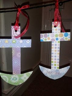 two paper crosses are hanging on a rope