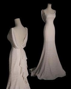 two white dresses on mannequins in the dark