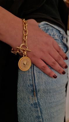 "♦ A beautiful gold Lion Bracelet Made of Brass Plated Matt And decorated with a Lion coin, is full of presence and style. The bracelet comes in 3 colors, gold, gold mix silver, silver The length ranges from 6.3\"(16 cm) to 8.2\"(21 cm). If you want a different length, please update me when you place your order. Width chain: 0.39\"( 1CM) Thickness: 0.19\" (0.5CM) Width coin: 1.19\" (3CM) ▪ You are welcome to see in the following link, a necklace set for the bracelet: https://etsy.me/3HyXMUc ▪ Go Chunky Gold Bracelet, Gold Medallion Necklace, Lion Bracelet, Toggle Clasp Bracelet, Fancy Packaging, Gold Lion, Gold Link Bracelet, Gold Link Chain, Gold Armband