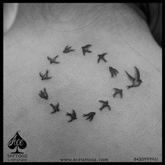 a black and white photo of birds flying in a circle on the back of a woman's neck