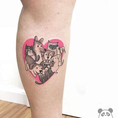 a woman's leg with a small tattoo of dogs and cats in the shape of a heart