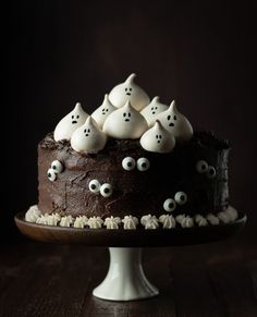 a chocolate cake topped with white frosting and spooky eyes