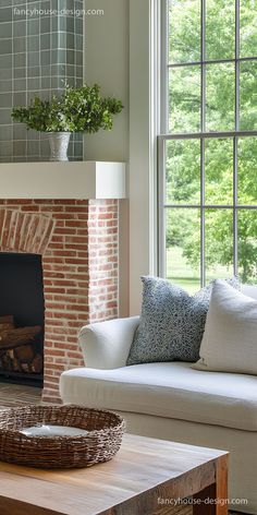 a living room filled with furniture and a fire place in front of a brick fireplace