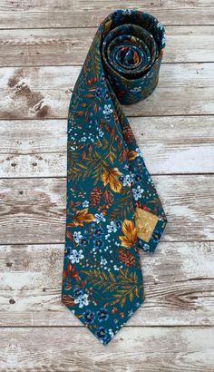 This tie is perfect for the cool, crisp days of Autumn. The colors of teal, browns and blues will compliment all styles. Also available in bowties! Handmade in St. Louis Missouri, USA All size ties for men and youth All size bowties adults and youth Pocket squares Face masks Floral Tie Wedding, Fall Ties, Dapper Fashion, Grooms Party, Teal Tie, Ties Mens Fashion, Wedding Classy, Groom Ties, Fall Fashions