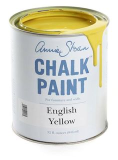 a can of yellow chalk paint sitting on top of a white table