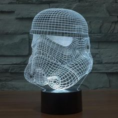 a star wars helmet is shown in the shape of a 3d lamp on a table