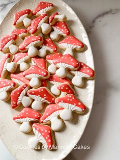 cookies decorated with red and white mushrooms on a plate