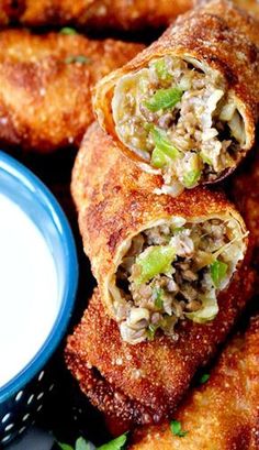 some fried food is on a plate with a small bowl of ranch dressing next to it