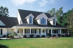 a large white house with black roof and windows