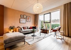 a living room filled with furniture and lots of windows