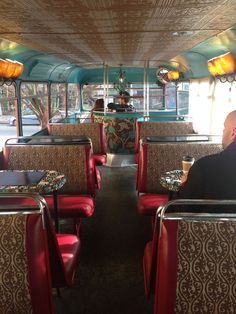 the inside of a bus with red seats