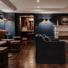 a living room filled with furniture and a fire place in the middle of it's walls