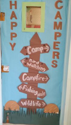 a door decorated with signs that say happy campers