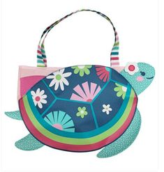 a handbag with a turtle on the front and flowers on the back, hanging from a string