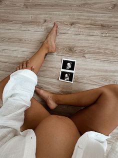 a woman laying on the floor with her legs crossed