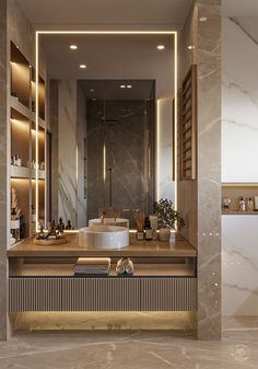 a modern bathroom with marble counter tops and gold trim around the sink, lighted by recessed lights