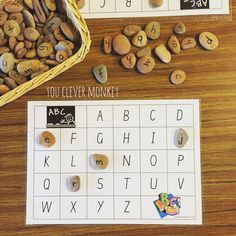 two different types of letters and numbers on a table with rocks in the shape of letters