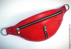 a red leather fanny bag with metal zippers