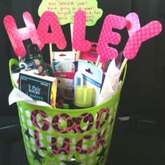 a green basket filled with lots of items and some writing on top of each other