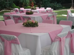 the tables are covered with pink and white linens