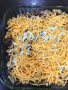 a casserole dish with cheese and ground beef