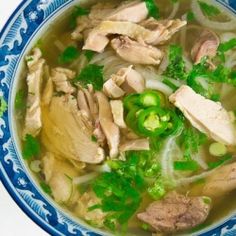 a blue and white bowl filled with soup