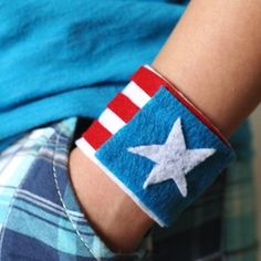 a person wearing a patriotic wristband with an american flag design on the band and white stars