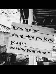 a sign that is on the side of a building saying if you are not doing what you love, you are wasteing your time