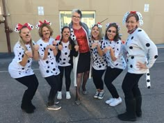 a group of women dressed up in dalmatian costumes posing for a photo together