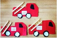 three firetrucks made out of construction paper on a wooden table with the number forty