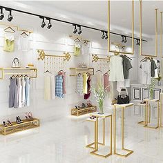 a clothing store with gold shelving and hanging clothes