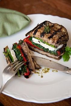 a grilled sandwich on a plate with a knife and fork