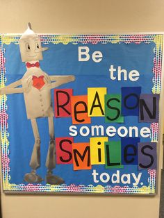 a bulletin board that says be the reason someone smiles today