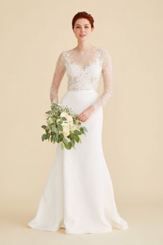 a woman in a wedding dress holding a bouquet