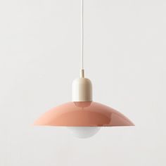 a pink and white light hanging from a ceiling