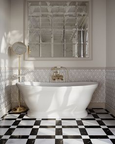 a white bath tub sitting in a bathroom next to a mirror and black and white checkered floor