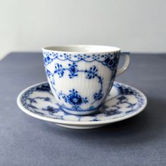 a blue and white tea cup sitting on top of a saucer