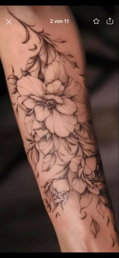 a woman's arm with flowers on it