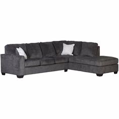 a gray sectional couch with white pillows on the armrests and one end facing it