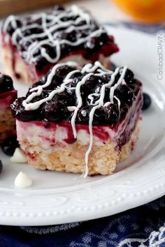 two pieces of blueberry cheesecake on a white plate