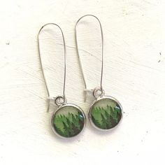 These handmade Forest earrings are such a perfect size- small enough for them to be your everyday earrings, but big enough to see all the details of the design clearly. They look very pretty on, and they elegantly hang from your ear. The ear wires are 925 sterling silver. The Bezels are American-Made and have a high-quality silver plating of an anti-tarnish Rhodium. This tiny print of an original seed & sky painting is encased in jeweler's resin for a water-proof, glass-like finish. This ima Painted Forest, Forest Earrings, Lover Jewelry, Tiny Prints, Sky Painting, Pretty Box, Douglas Fir, Everyday Earrings, Jewelry Business