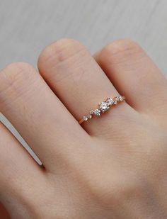 a woman's hand with a diamond ring on it