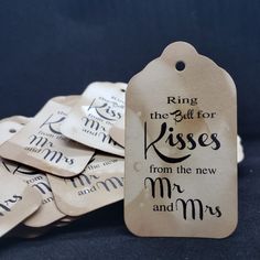 a pile of tags with the words ring the bell for kisses from the new mr and mrs