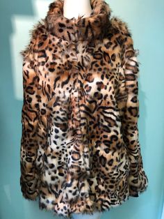 "Kitty- kitty jacket with two pockets and adjustable sleeves two-way-to-wear, elastic  black cuffs or band them in. Back length is 27\", sleeves length with cuffs are 27\", the plain sleeve length is 24\".  Jacket has a stand collar 2\" wide. Dry clean only. Available in size S,M,L." Womens Jackets, Kitty Kitty, A Stand, Faux Fur Jacket, Fur Jacket, Stand Collar, Fur Coat, Faux Fur, Bathing Beauties