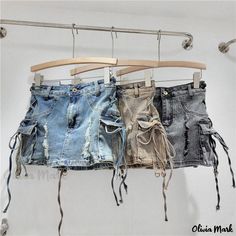 Olivia Mark - Vintage Distressed Denim Skirt with Tie Waist - High Waisted, Stylish, and Edgy Mini Skirt High Waist Ripped Mini Skirt For Summer, Ripped High Waist Mini Skirt For Summer, Summer Ripped Mini Skirt, Summer Mini Skirt With Ripped Details, Distressed Mini Skirt For Summer, High Waist Distressed Skirt For Summer, Summer Distressed Denim Skirt, Denim Blue Cotton Cargo Skirt For Summer, Summer Denim Blue Cotton Cargo Skirt