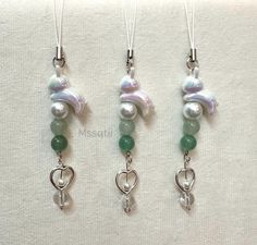 three necklaces with pearls and green beads