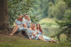 a family posing for a photo in front of a tree